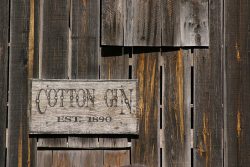 Old,Weathered,Cotton,Gin,Sign,Close,Up.